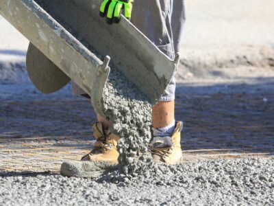 This is an image of a contractor pouring concrete onto a building foundation.